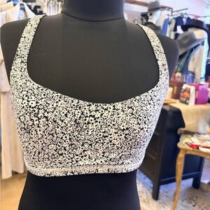 Lululemon basic sports bra size 8 with black daisy flowers.